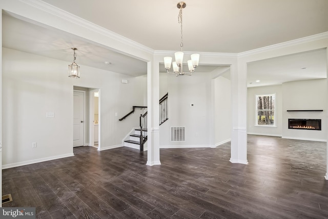 interior space featuring ornamental molding, dark hardwood / wood-style floors, and a chandelier