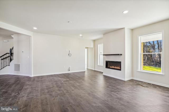 unfurnished living room with dark hardwood / wood-style floors