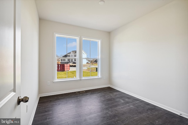 unfurnished room with dark hardwood / wood-style floors