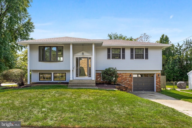 split foyer home featuring a front yard and a garage