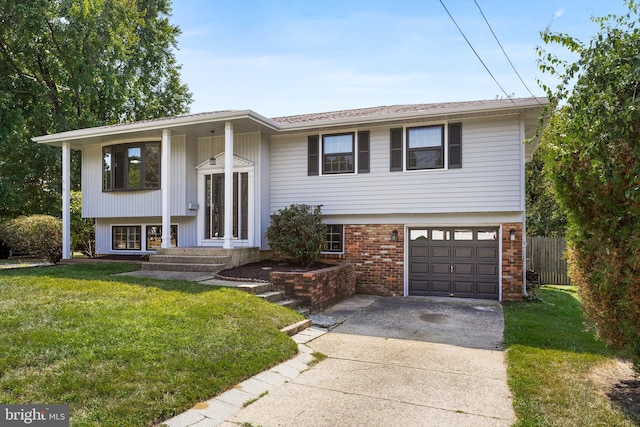 raised ranch featuring a garage and a front yard