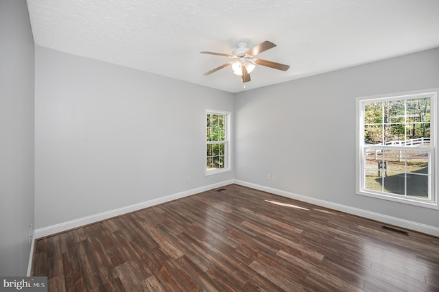 spare room featuring ceiling fan, a textured ceiling, and dark hardwood / wood-style floors