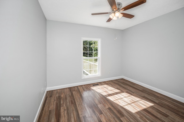 spare room featuring ceiling fan, a textured ceiling, and dark hardwood / wood-style flooring