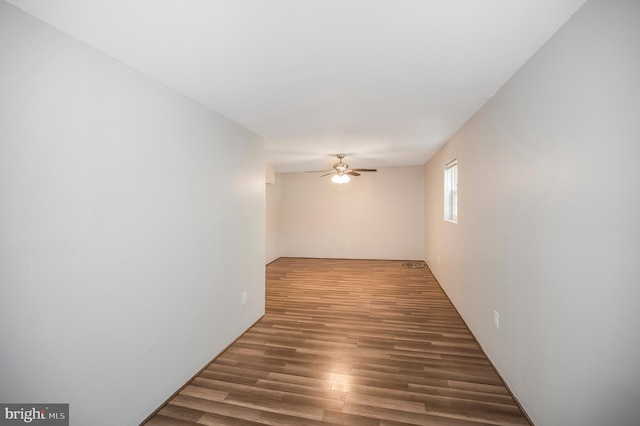 unfurnished room featuring ceiling fan and dark hardwood / wood-style flooring