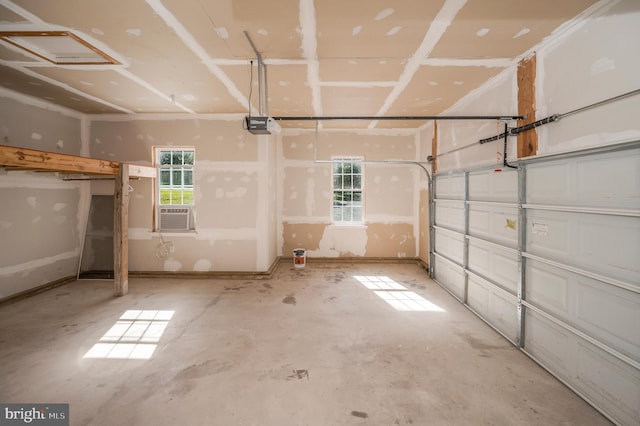 garage featuring a garage door opener and cooling unit