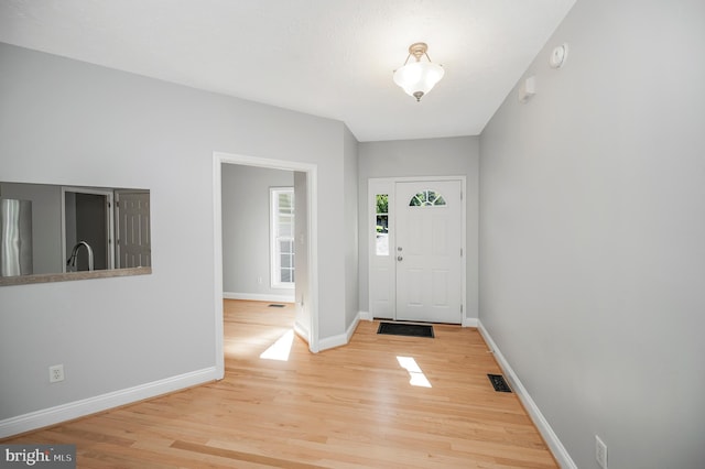 foyer featuring light wood-type flooring and sink