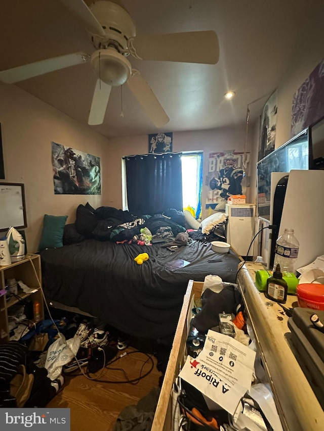 bedroom with ceiling fan and hardwood / wood-style floors