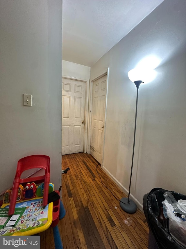 hallway with dark wood-type flooring