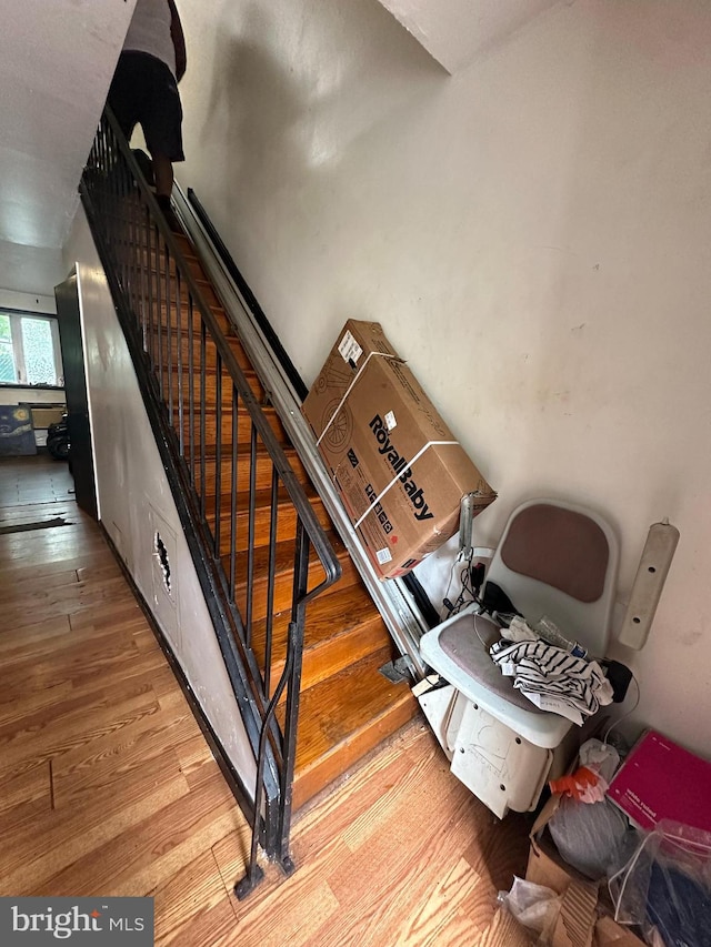 staircase with hardwood / wood-style floors