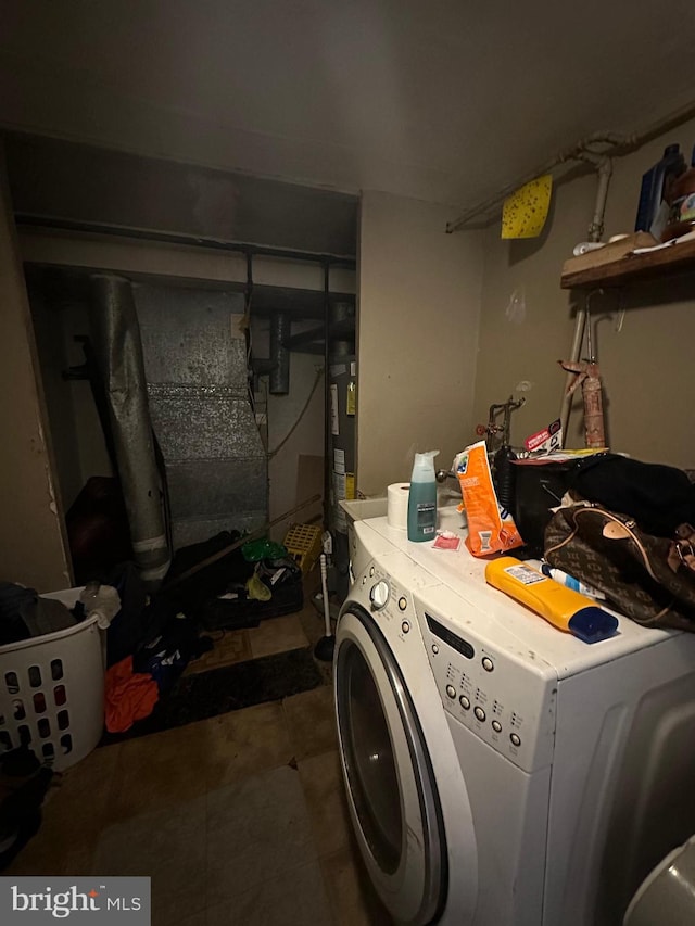 clothes washing area featuring washer / clothes dryer and water heater