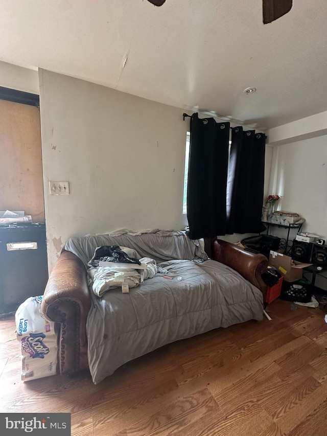 bedroom with ceiling fan and hardwood / wood-style floors