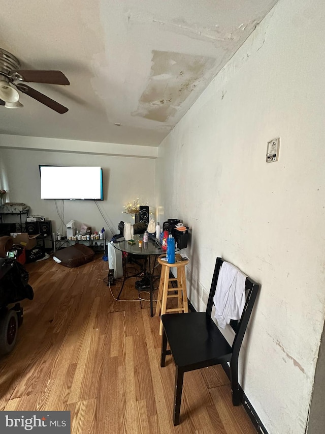 interior space featuring wood-type flooring and ceiling fan