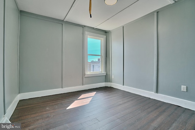 empty room with ceiling fan and hardwood / wood-style flooring