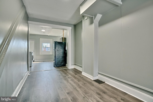 interior space with washer / dryer and light hardwood / wood-style floors