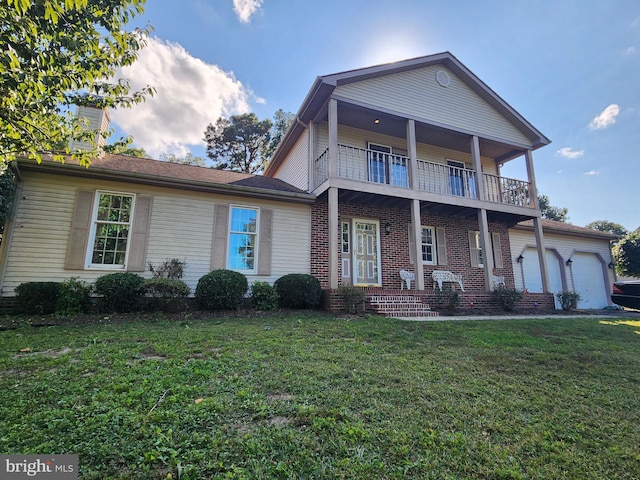 view of front property with a front yard and a balcony