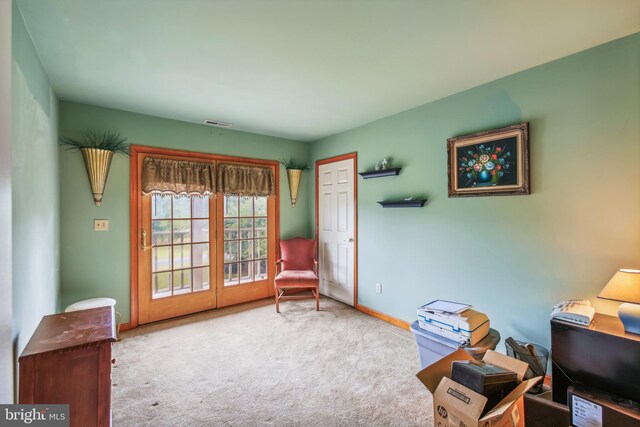 sitting room featuring light carpet