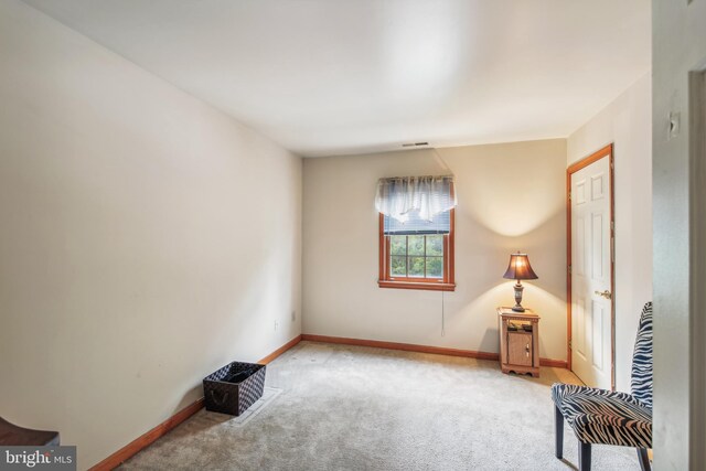 sitting room featuring light carpet