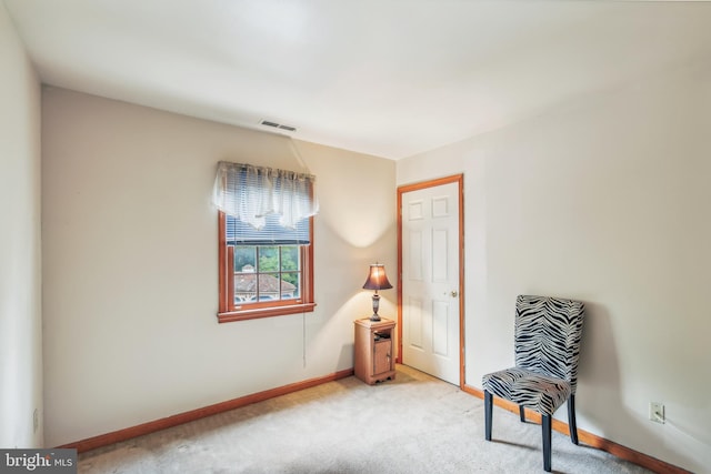 living area with light carpet