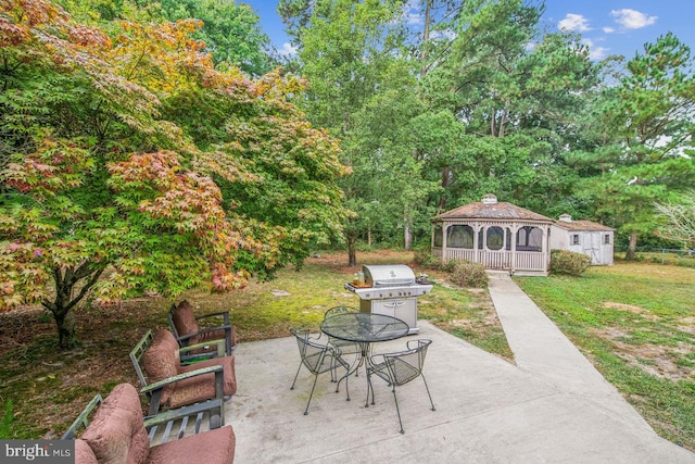 view of patio / terrace with an outdoor structure and a grill