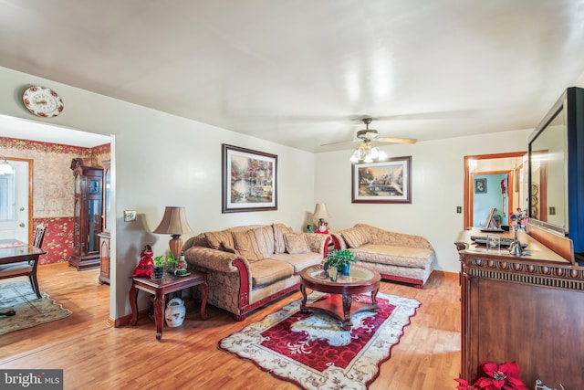 living room featuring ceiling fan and light wood-type flooring