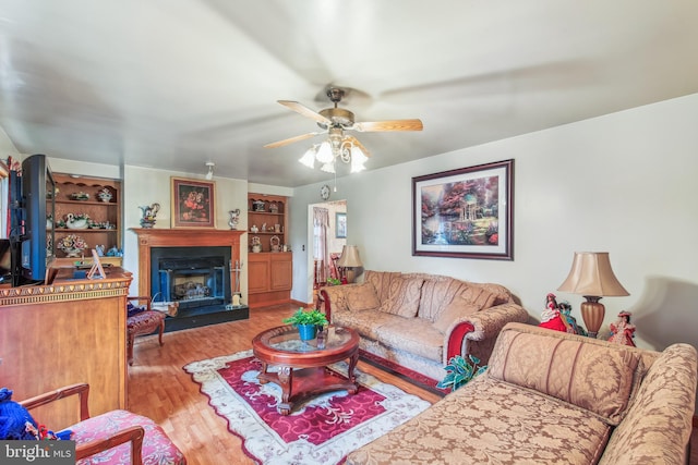 living room with ceiling fan and wood-type flooring