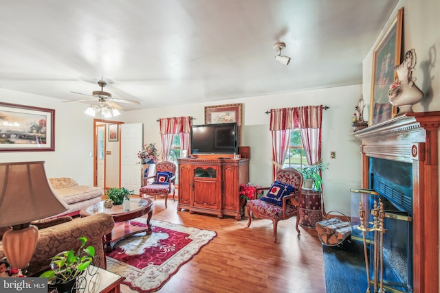 living room with light hardwood / wood-style flooring and ceiling fan