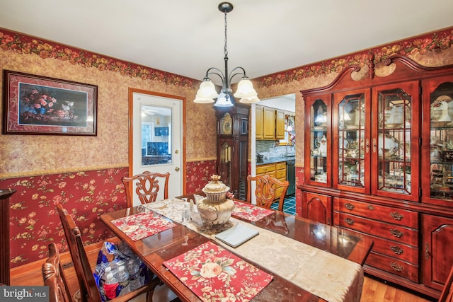 dining area with hardwood / wood-style flooring and a chandelier