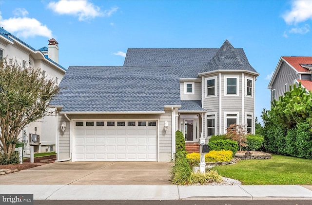 view of front of property with a front yard and a garage