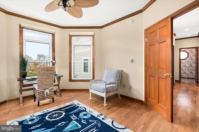 sitting room with crown molding, hardwood / wood-style floors, plenty of natural light, and ceiling fan