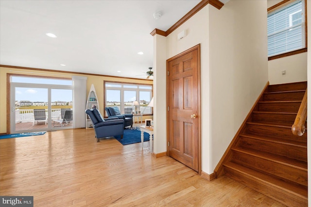 interior space with crown molding, light hardwood / wood-style flooring, and ceiling fan