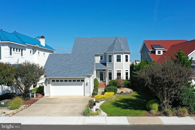 view of front facade with a front lawn and a garage