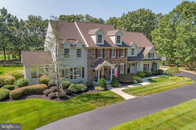 colonial inspired home with a front yard