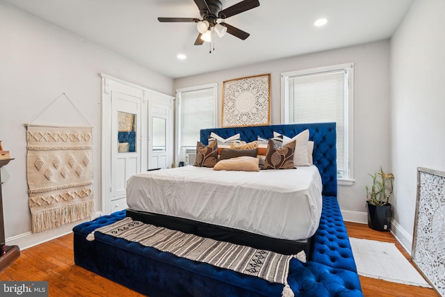 bedroom featuring a ceiling fan, recessed lighting, wood finished floors, and baseboards