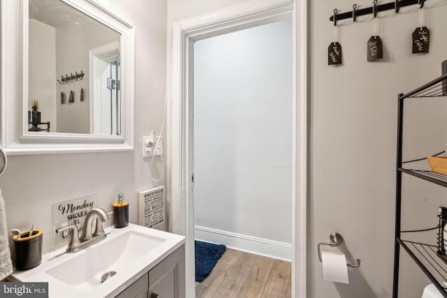 bathroom with wood finished floors and vanity