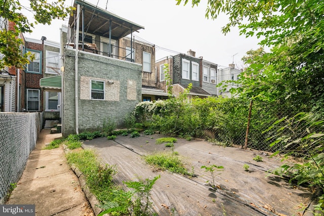 back of house featuring fence