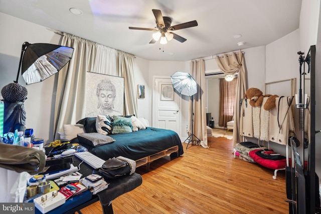 bedroom with ceiling fan and wood finished floors