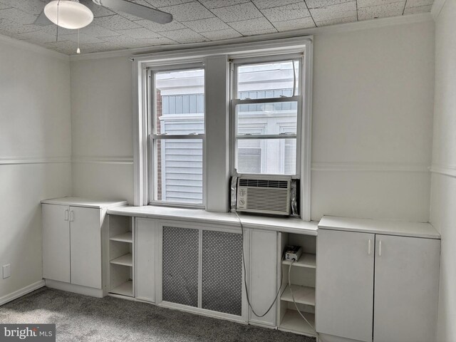 unfurnished office with crown molding and light carpet