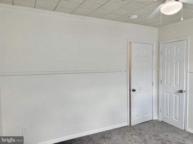 carpeted spare room with crown molding