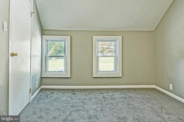 carpeted spare room featuring plenty of natural light