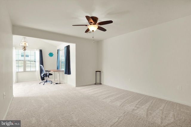 carpeted empty room featuring ceiling fan