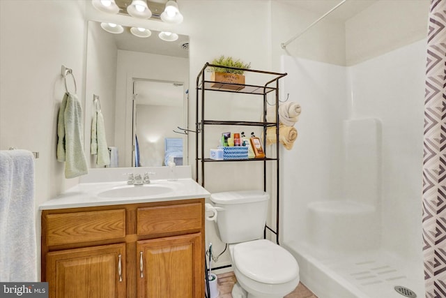 bathroom with vanity, toilet, and walk in shower