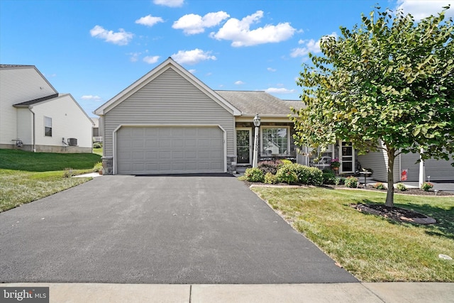 view of front of property featuring a front lawn and a garage