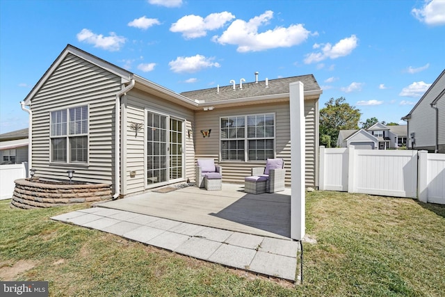 back of house featuring a lawn and a patio