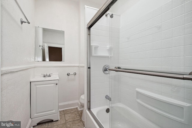 full bathroom with toilet, vanity, and bath / shower combo with glass door