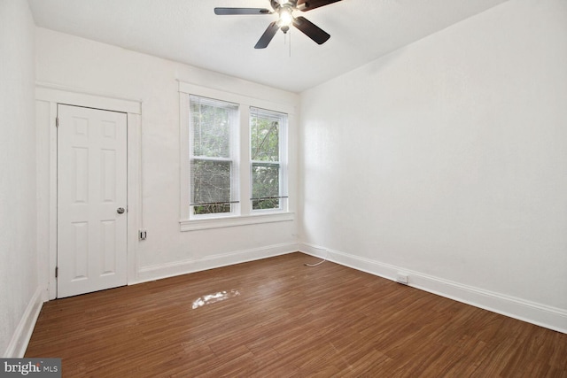 unfurnished room with a ceiling fan, baseboards, and wood finished floors