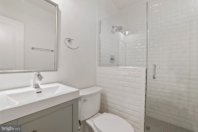 bathroom featuring vanity, toilet, and walk in shower