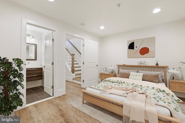 bedroom featuring wood-type flooring and ensuite bathroom