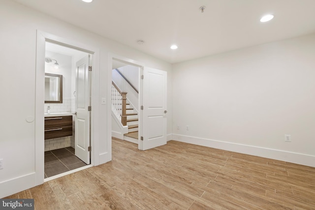 interior space with hardwood / wood-style floors and ensuite bath