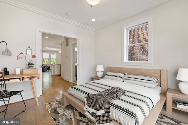 bedroom with crown molding and light hardwood / wood-style flooring