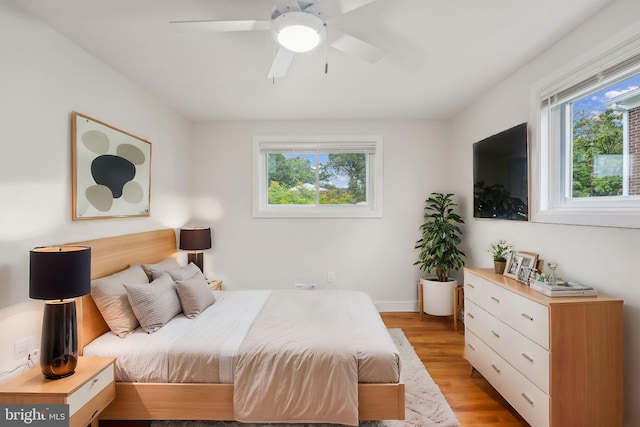 bedroom featuring light wood-type flooring and ceiling fan